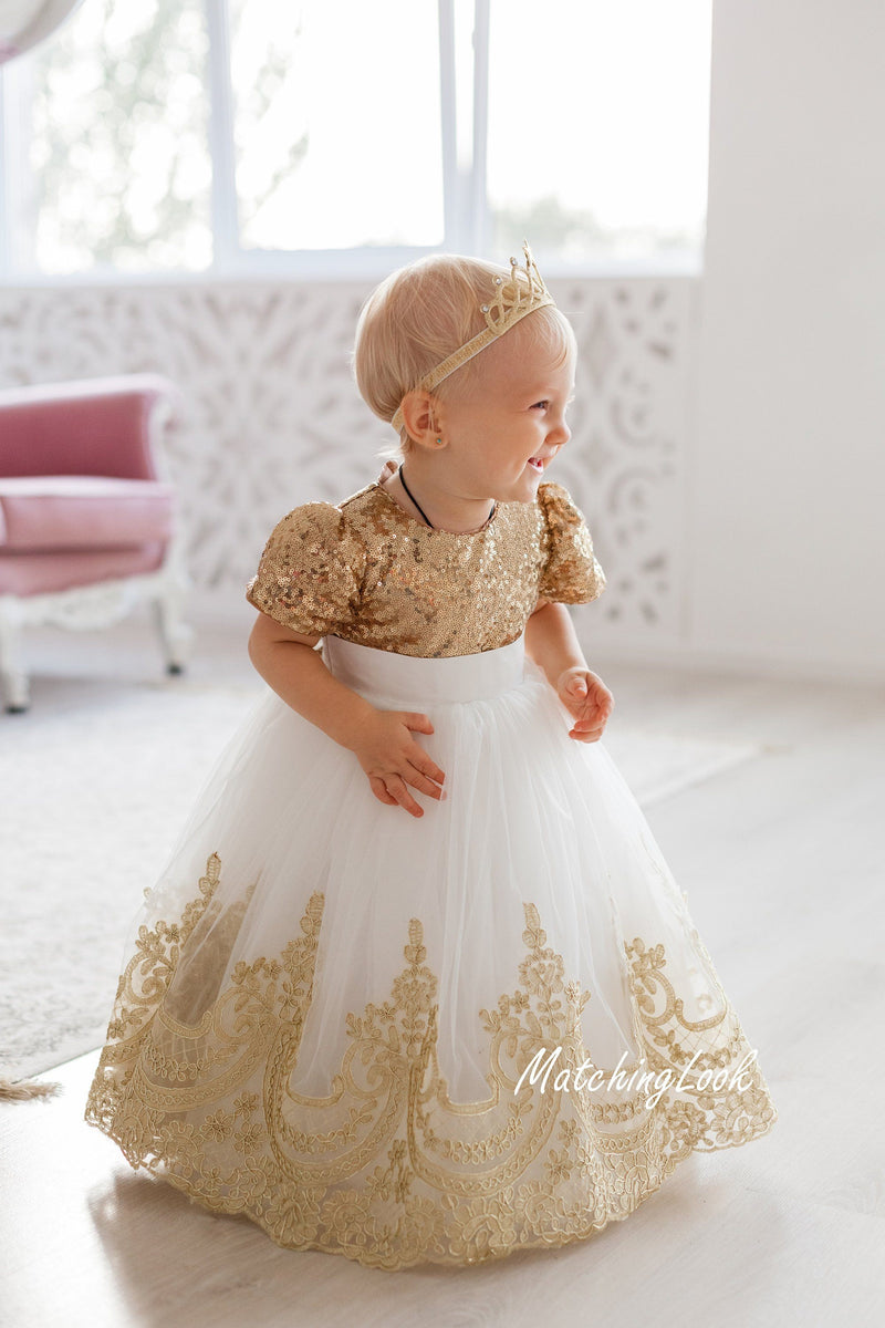 Gold baby girl princess dress with sequins and lace trim on tutu bottom part